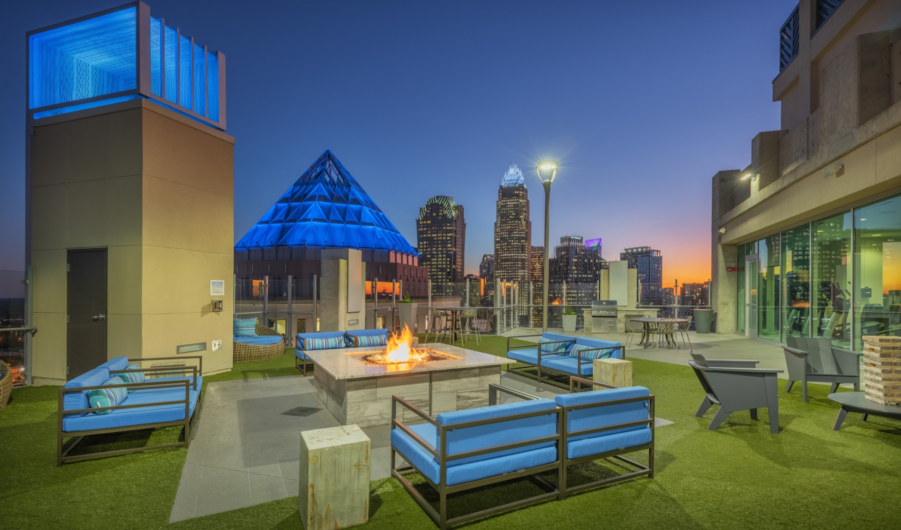 Outdoor seating with a firepit at The Ascher Uptown apartments in Charlotte