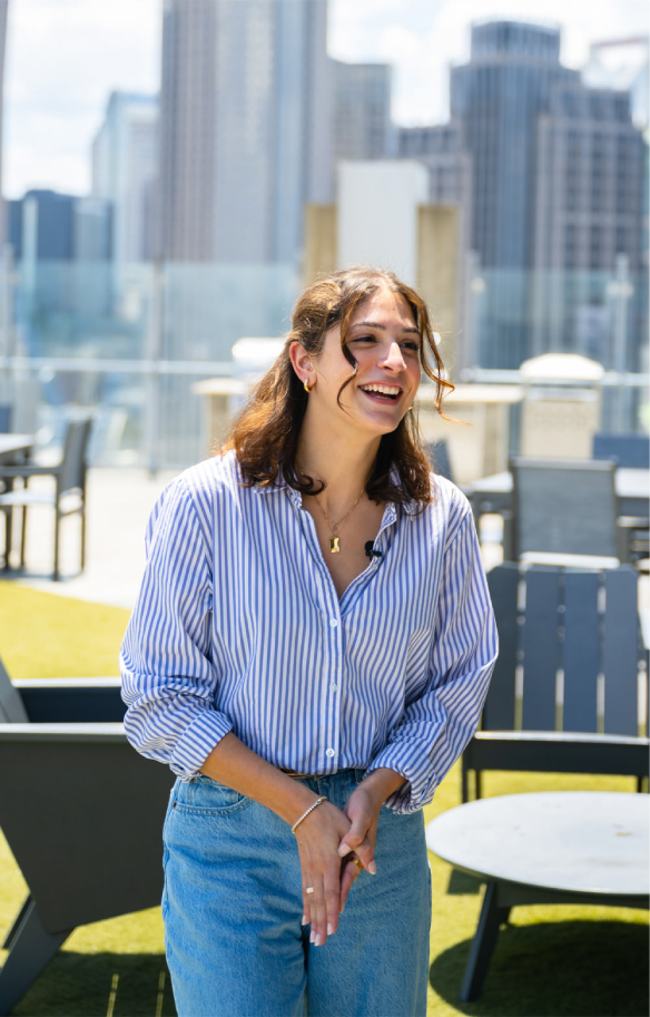 woman smiling with city behind her
